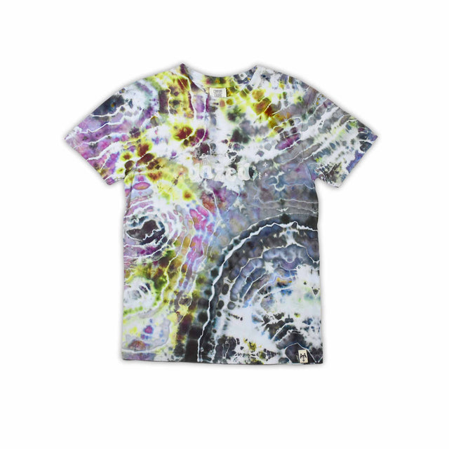An artisanal ice-dyed t-shirt, its surface a canvas of swirling blues, purples, and chartreuse resembling geode formations, with the text 'dazed' in a stylized, icy lettering at the center.