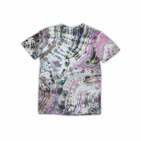 An artisanal ice-dyed t-shirt, its surface a canvas of swirling blues, purples, and chartreuse resembling geode formations, with the text 'dazed' in a stylized, icy lettering at the center.