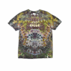 An eye-catching ice-dyed t-shirt showcasing a vibrant explosion of purples, pinks, and grays with a smoky effect around the 'dazed' text featured in the center.