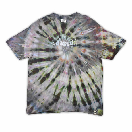 This t-shirt displays an intricate ice-dye effect that creates a starburst pattern with a mix of earthy and vibrant colors, highlighted by 'dazed' text in the middle in a style reminiscent of melting ice.