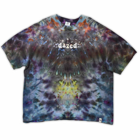 An ice-dyed t-shirt with a mesmerizing array of blues, purples, and subtle greens, reminiscent of a frozen geode, with 'dazed' in an icy font across the chest.