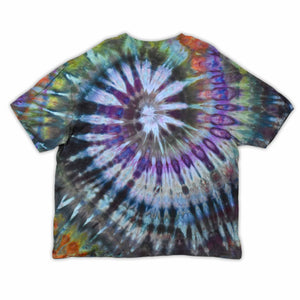 This t-shirt displays a stunning ice-dye technique creating a crystalline effect with vibrant blues, purples, and greens emanating outwards, with 'dazed' situated in the middle in a funky font.