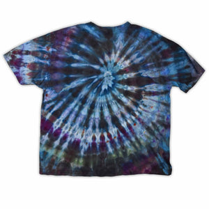 This t-shirt displays a stunning ice-dye technique creating a crystalline effect with vibrant blues, purples, and greens emanating outwards, with 'dazed' situated in the middle in a funky font.