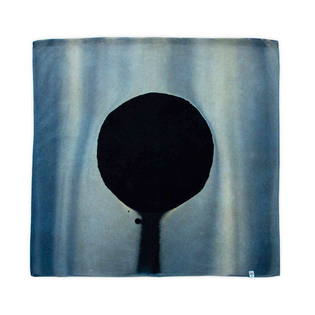 Hand-dyed bandana with a unique ice dye effect, displaying a central resist circle resembling a solar eclipse on a sky-blue backdrop.