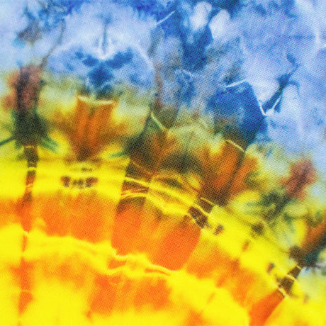 his bandana showcases a dynamic tie-dye representation of a sun with radiating beams, transitioning from a fiery orange core to a yellow halo, against a cool blue and green backdrop.