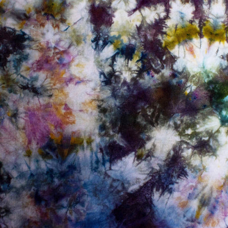 The bandana showcases a textural ice dye technique that creates a painterly, impressionistic blend of lilac, navy, moss green, and hints of sunshine yellow.