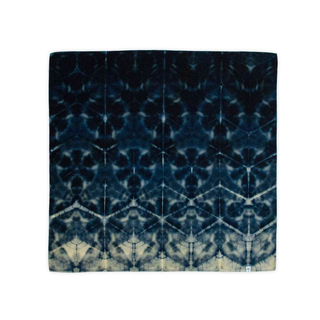 This bandana features the traditional Japanese itajime technique, displaying a stark, tessellated pattern in pure black and natural ecru.