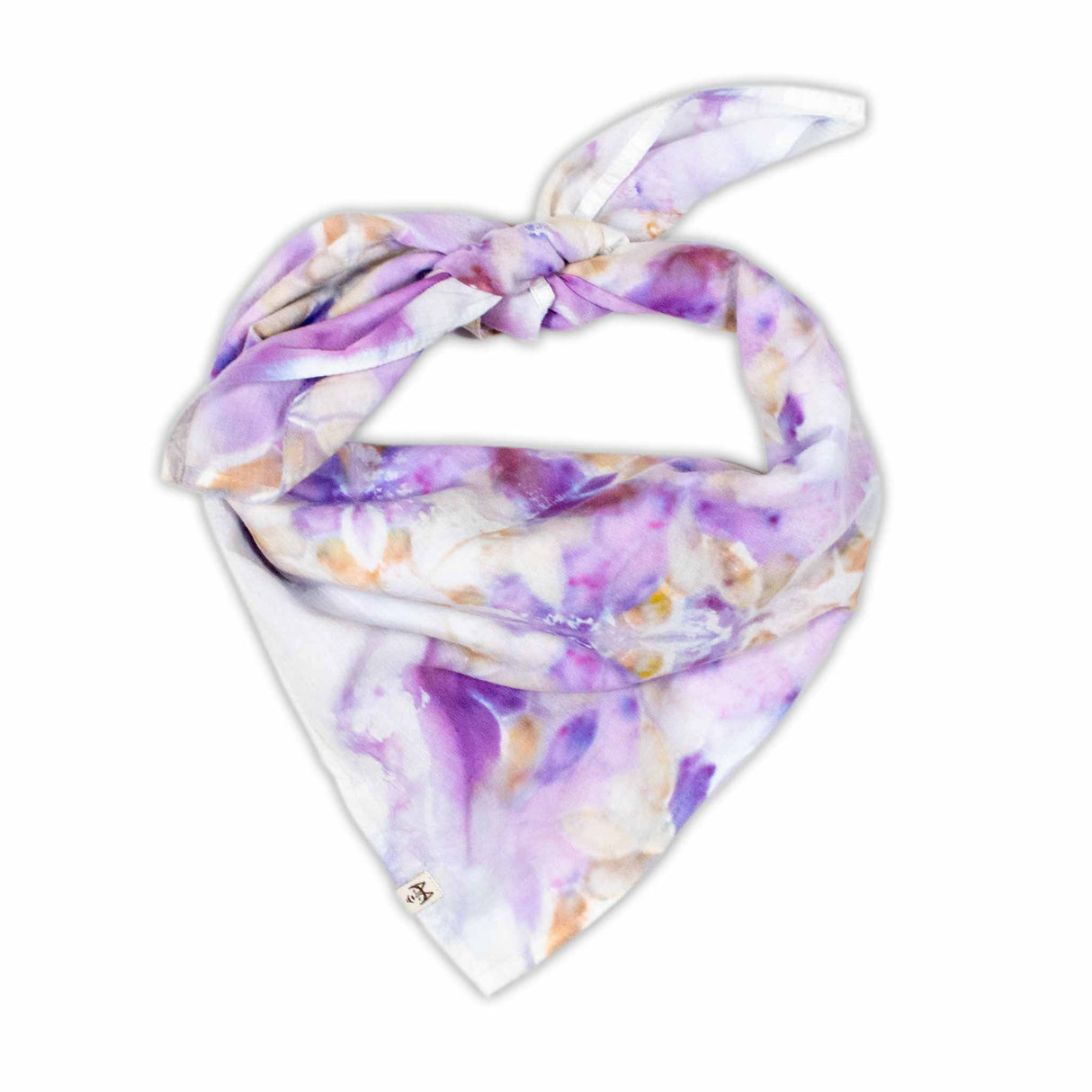 Handcrafted tie-dye bandana with a vibrant display of purple hues and white areas that symmetrically bloom into a pattern reminiscent of flowers and mandalas.