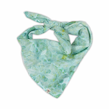 A soothing green tie-dyed bandana with a delicate pattern that mimics a garden of abstract flowers, featuring various shades of green and subtle yellow highlights.