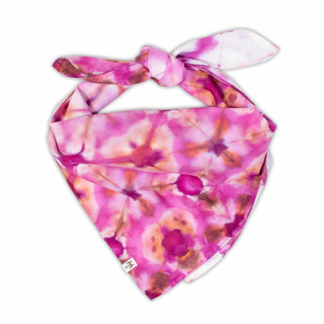 Vivid fuchsia and soft pink hues create a striking tie-dye grid on this bandana, intersected by bold pink points and surrounded by flower-like splashes.