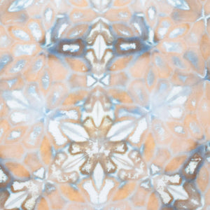 Earth-toned tie-dyed bandana displaying a symmetrical pattern with elements that suggest flowers and stars, in a soft palette of beige, grey, and white.