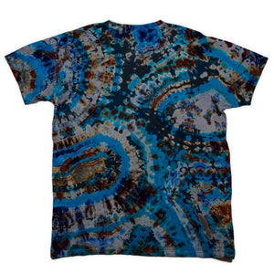 The t-shirt boasts a complex reverse dye design, reminiscent of a cross-section of a geode, with layered blue and brown circular patterns.