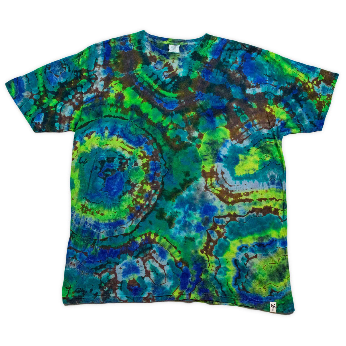 Nature-inspired reverse dyed t-shirt with circular patterns that capture the essence of a colorful geode, predominated by shades of blue and green.