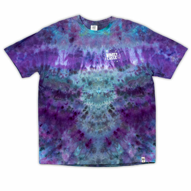 The 'Dinkey Creek' logo pops against the swirling backdrop of an ice dye design in rich purples and blues on this comfortable t-shirt.