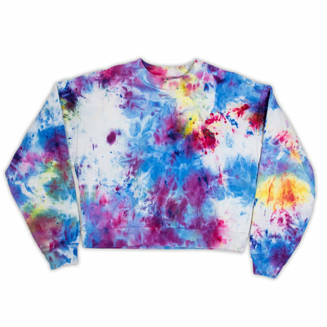 A snug and stylish cropped sweatshirt for women, with an eye-catching ice dye mix of warm pinks, cool blues, and vibrant yellows, perfect for a cozy day in or a casual outing.