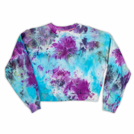A stylish cropped sweatshirt designed for women, adorned with a cloudy tie-dye pattern in shades of purple and blue.