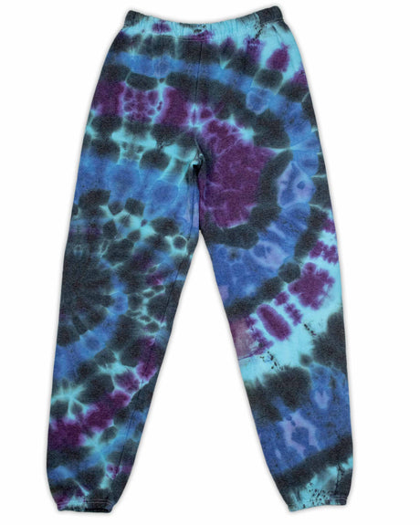 A pair of ice-dyed sweatpants, with a cosmic array of dark blues and purples, reminiscent of a nebula's mysterious beauty.