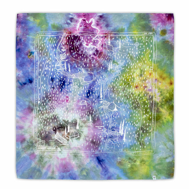 This bandana showcases a detailed white screen-printed topographical map of Dinkey Creek, overlaying a vibrant, ice-dyed backdrop with dynamic swirls of purple, blue, and green.
