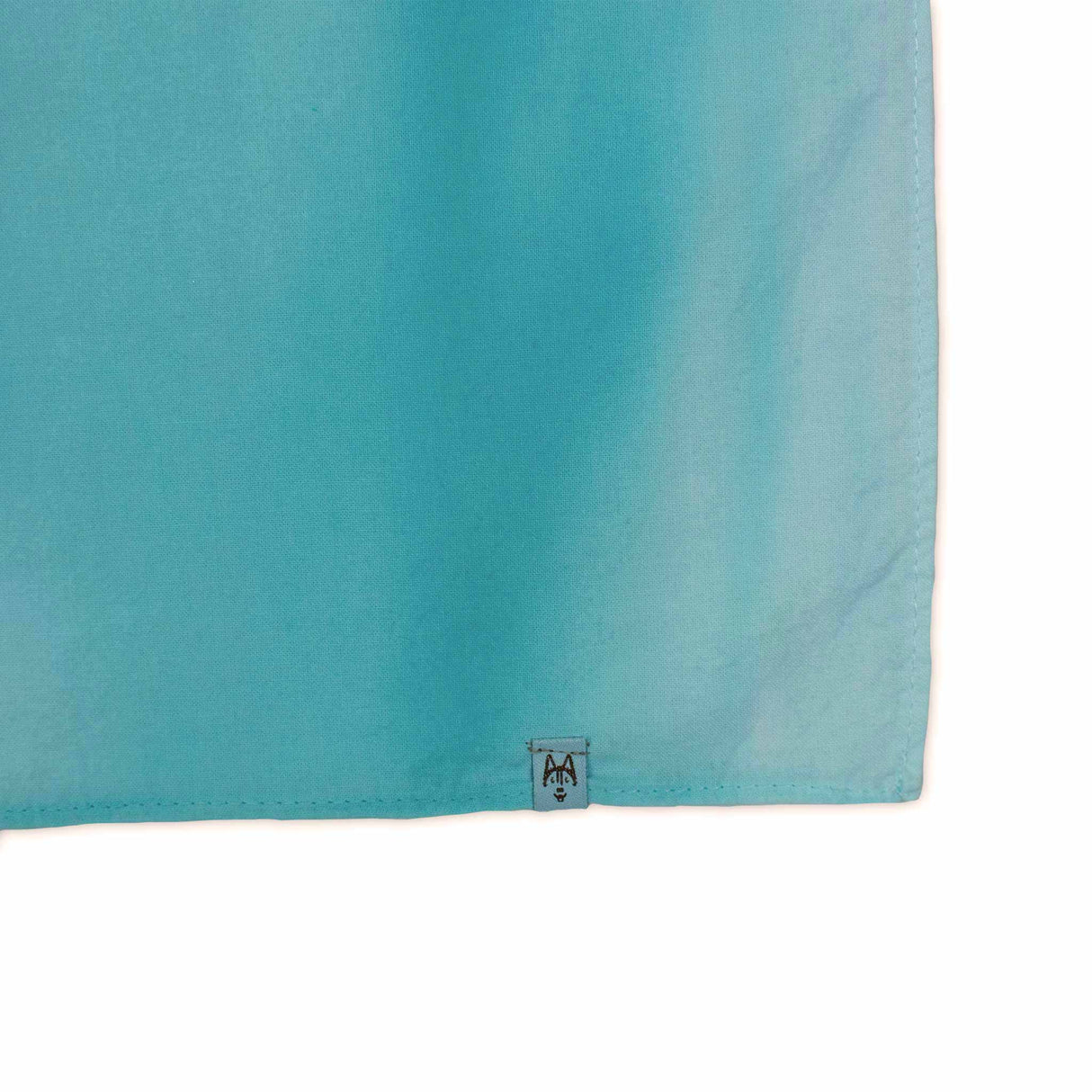 This bandana displays a dreamy ice-dye pattern with aqueous tones of green and blue, reminiscent of a gentle underwater current.