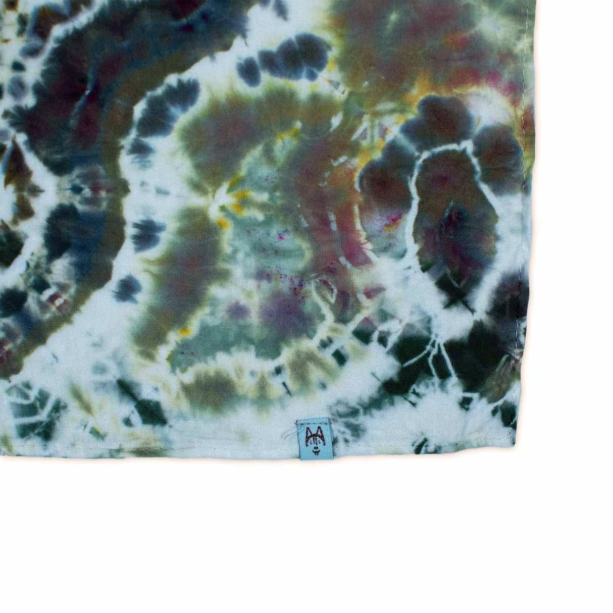 A hand-dyed bandana capturing the essence of mineral formations with its ice dye design, presenting a mix of silvery grey and rustic brown with a network of white veins.