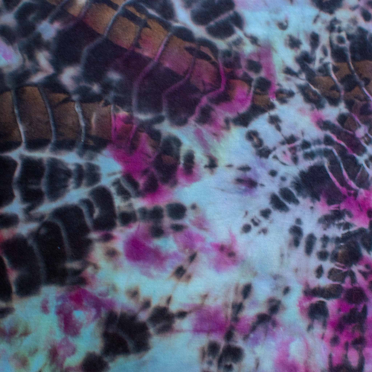 Long-sleeved t-shirt featuring a dual tie-dye technique, with intricate patterns of black crackle and bursts of pink and aqua blue, creating a visually striking and unique design.