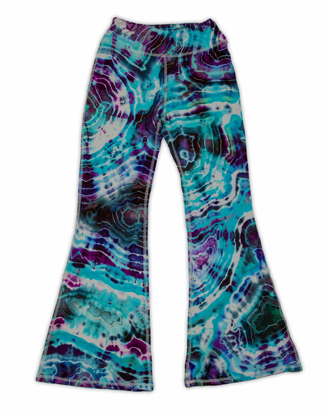 A pair of hand-dyed pants showcasing a unique ice-dye technique with organic patterns in a striking combination of sapphire, violet, and seafoam green.