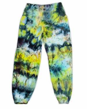 A pair of colorful sweatpants with a striking tie-dye pattern, presenting a kaleidoscopic effect with shades ranging from lime green to ocean blue and charcoal.