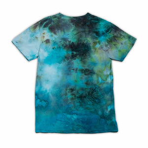 An ice-dyed t-shirt with a fluid, watercolor-like pattern in shades of cerulean, teal, and indigo, evoking a serene aquatic scene.