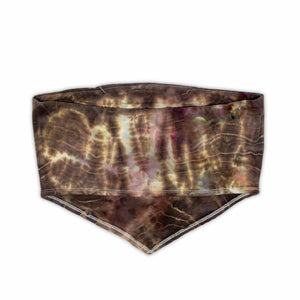 A bohemian-style bandeau top with a moody ice-dyed design, showcasing a blend of deep browns, creams, and specks of pastel hues.