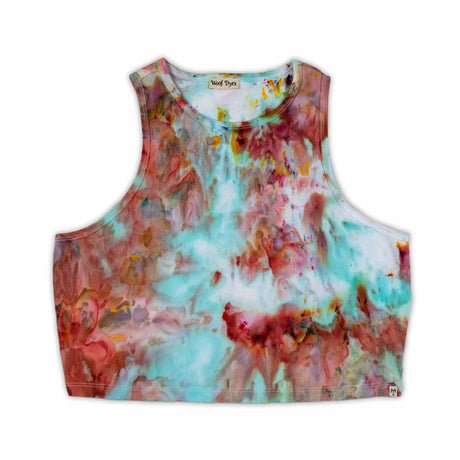 An ice-dyed sleeveless tank top, with a blend of warm terracotta, gentle azure, and cloudy whites in an abstract, fluid design.
