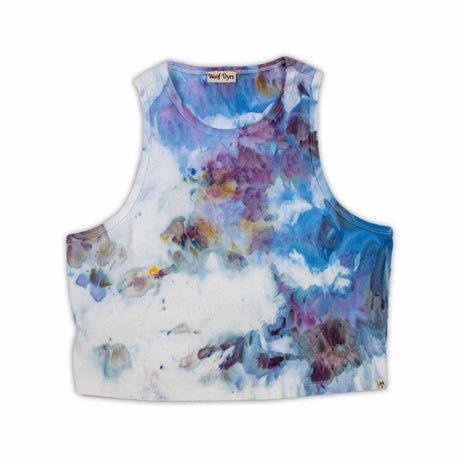 A women's high-neck cropped tank top featuring a soft ice dye pattern with swirls of blue, purple, and white on a white background, creating a dreamy, cloud-like effect. 