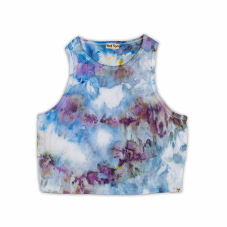 A women's high-neck cropped tank top featuring a soft ice dye pattern with swirls of blue, purple, and white on a white background, creating a dreamy, cloud-like effect. 